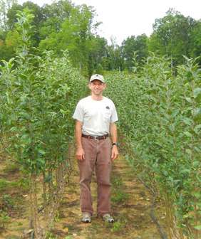 david standing in field of trees